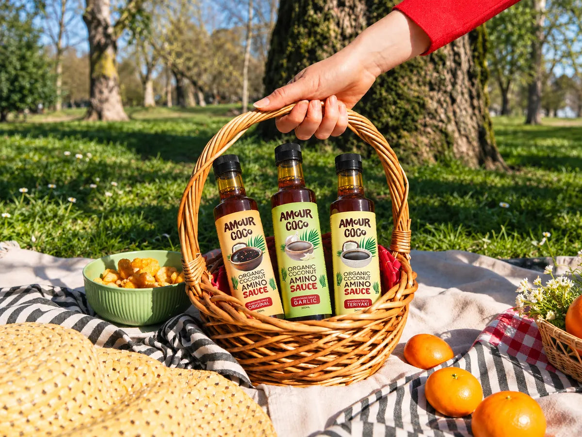 Garlic, Original and Teriyaki coconut amino sauces in a picnic basket